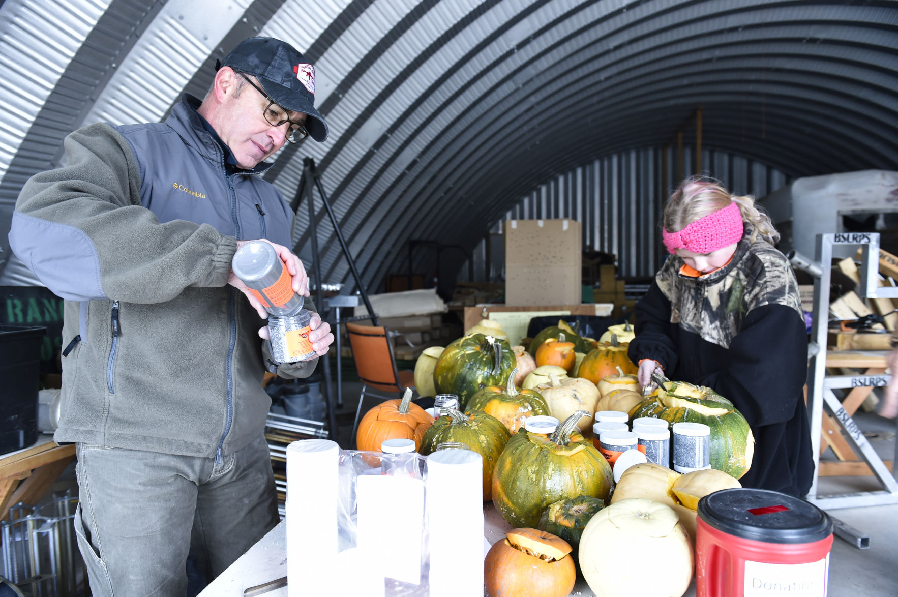 Tim Swingle, left, mixes Tannerite Saturday to stuff in pumpkins destined to be shot at.